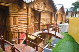 a log cabin with wooden stairs in front of it at La Das Treetops in Kurseong