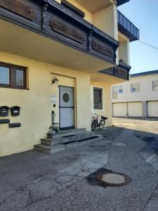 a building with a door and a bike parked outside at Charly's Home in Villach