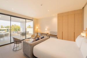 a bedroom with a bed and a living room at Eurostars Oasis Marbella in Marbella