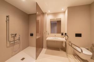 a bathroom with a sink and a shower and a toilet at Eurostars Oasis Marbella in Marbella