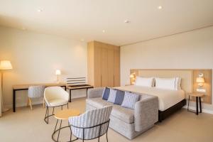 a hotel room with a bed and a couch at Eurostars Oasis Marbella in Marbella