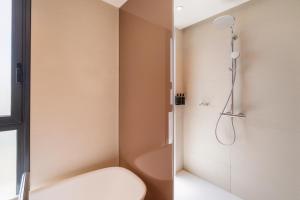 a bathroom with a shower and a toilet at Eurostars Oasis Marbella in Marbella