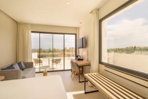 a hotel room with a large window and a living room at Eurostars Oasis Marbella in Marbella