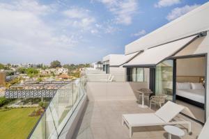 an apartment balcony with a view of a city at Eurostars Oasis Marbella in Marbella