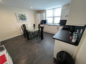 cocina y comedor con mesa y sillas en Spacious ground floor suite comfortably sleeps up to eight, en Halifax