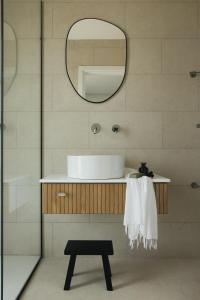 a bathroom with a sink and a mirror at Ostrea Villas in Paleros