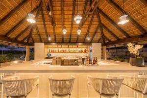 a lobby with chairs and a bar in a building at Eurostars Oasis Marbella in Marbella
