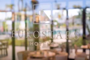 a sign for a restaurant with tables and chairs at Eurostars Oasis Marbella in Marbella