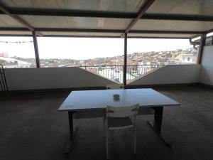 a table and a chair in a room with a view at Appartamento Sicilia vicino Caltagirone - Niscemi in Niscemi +2 photos