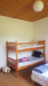 a bedroom with two bunk beds and a wooden ceiling at Gite de l'école 