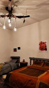 a bedroom with two beds and a ceiling fan at Grandma's house in Wadi Musa