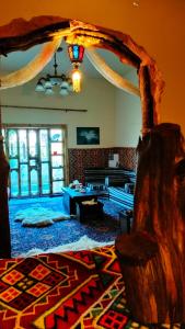 a living room with a table and a rug at Grandma's house in Wadi Musa