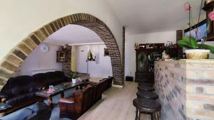 an archway in a living room with a couch and chairs at LA RĂSCRUCE DE APE in Suceviţa