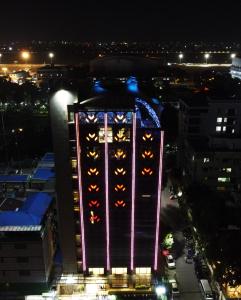 a tall building with lights on it at night at The Zabeer Dhaka in Dhaka