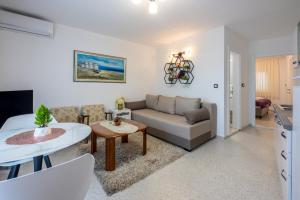 a living room with a couch and a table at Villa Lucia 2 in Dramalj