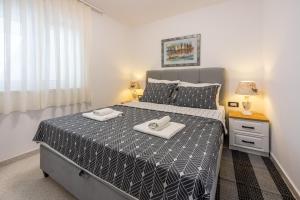 a bedroom with a bed with two towels on it at Villa Lucia 2 in Dramalj