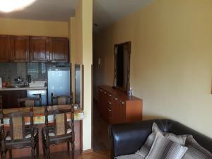 a living room with a couch and a table and a kitchen at Bulevar apartment Budva in Budva