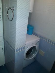 a small bathroom with a toilet in a stall at Bulevar apartment Budva in Budva
