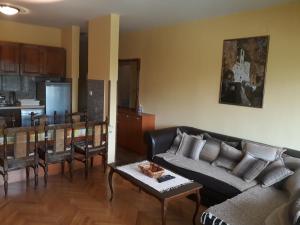 a living room with a couch and a table at Bulevar apartment Budva in Budva