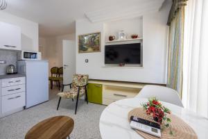 a living room with a table and a kitchen at Villa Lucia 2 in Dramalj