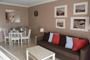 uma sala de estar com um sofá e uma mesa em Residencial La Quinta Park Suites em Santa Úrsula
