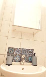 a bathroom with a sink with two candles on it at Cozy Studio Strasbourg in Strasbourg +8 photos