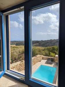 a view from the window of a house with a swimming pool at Sea Holly Gozo in Nadur