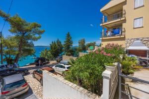 a building with cars parked in front of the water at Villa Lucia 2 in Dramalj