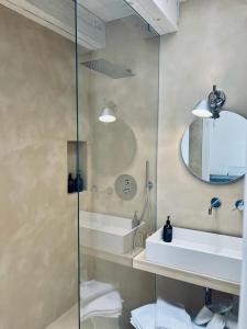 a bathroom with a shower and a sink and a mirror at Masseria Monè in Monopoli