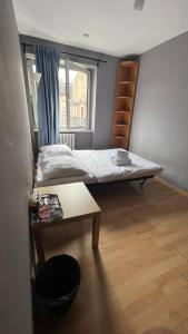 a bedroom with a bed and a table in it at roomspoznan pl - Rybaki 15 - 24h self check-in in Poznań