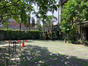 a courtyard with orange cones in front of a building at Nirwana Suites in Denpasar