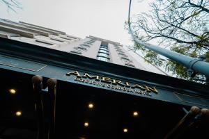 a tall building with a sign on the side of a restaurant at Amérian Executive Córdoba Hotel in Córdoba