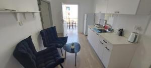 a kitchen with two chairs and a table in it at יחידות אירוח נוף המפרץ in Haifa
