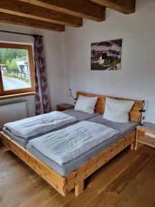 ein Schlafzimmer mit einem Holzbett in einem Zimmer in der Unterkunft Schickster Mountain Lodge in Unterweidach