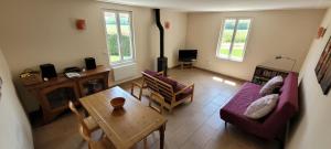 a living room with a couch and a table at Les Chails Gite in Les Forges