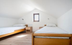a bedroom with two beds and a window at Villa Ivanka in Neum