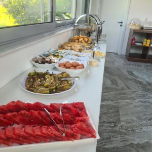 a buffet with many plates of food on a counter at Sunrise Apart-Hotel in Ulcinj