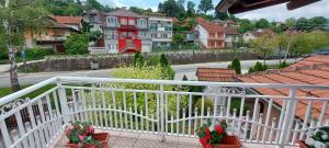 a balcony with a view of a street and houses at Vila Ondina in Donji Milanovac