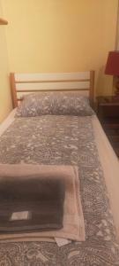 a bed in a bedroom with a bedspread on it at Appartamento Varese in Varese