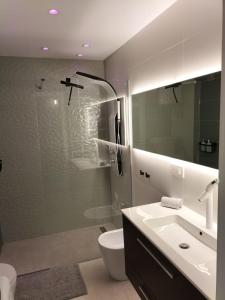 a bathroom with a sink and a toilet and a mirror at Las Meninas Tenerife in San Miguel de Abona