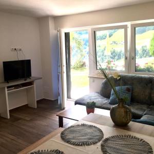 A television and/or entertainment centre at Haus Reimon Apt Reinhard