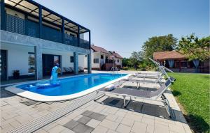 a swimming pool with chaise lounge chairs and a swimming pool at Awesome Home In Sedlarica With Private Swimming Pool, Can Be Inside Or Outside 