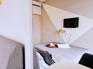 a room with a table with a bed and a tv at New! 4-6pax Mount Austin High Condo in Johor Bahru in Johor Bahru