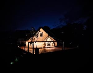 a white tent lit up at night at Pensiunea Cocoș 