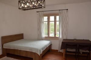 a bedroom with a bed and a window and a table at Вершище in Urych