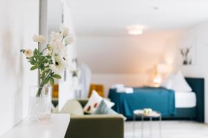 a vase of flowers on a table in a room at New Living City Appartement in Bielefeld
