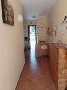 a bathroom with a toilet and a tile floor at Piccola Perla Guest House in Valmontone