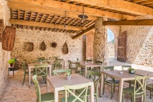 TognazzaAgriturismo Casalino18的石墙内带桌椅的餐厅