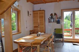 a kitchen with a large wooden table and chairs at Uroczy domek letniskowy. in Falsztyn