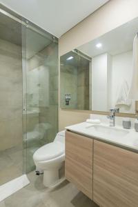 a bathroom with a toilet and a sink and a shower at Apartametos FACILE in Bogotá +12 photos